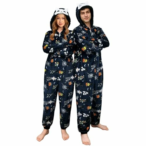 Couple wearing matching animal-themed onesies with hoods, smiling and having a great time together.