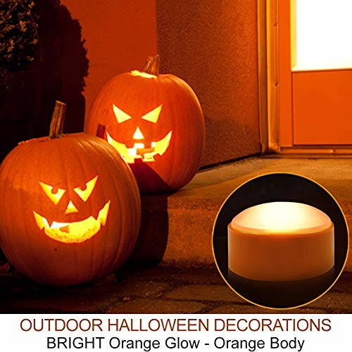 Glowing carved pumpkins with LED candle for Halloween decoration.