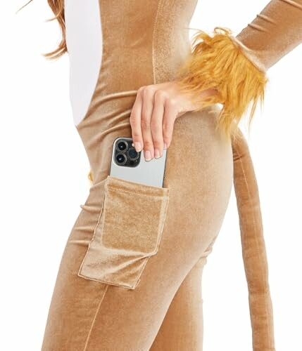 Person wearing a lion costume with a phone in pocket