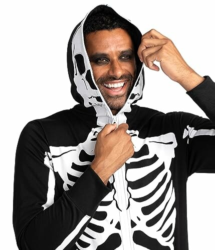 Smiling man in a skeleton costume with hood